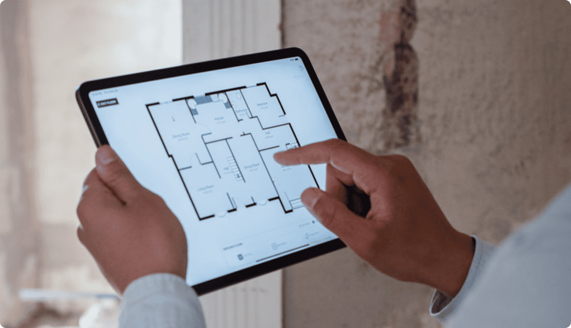Contractor holding ipad with a magicplan floor plan selecting and modifying rooms