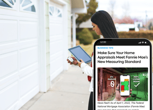 Appraisal professional in the house exterior with an ipad and phone with article preview on: Make sure your home appraisals meet fannie mae's new measuring standard