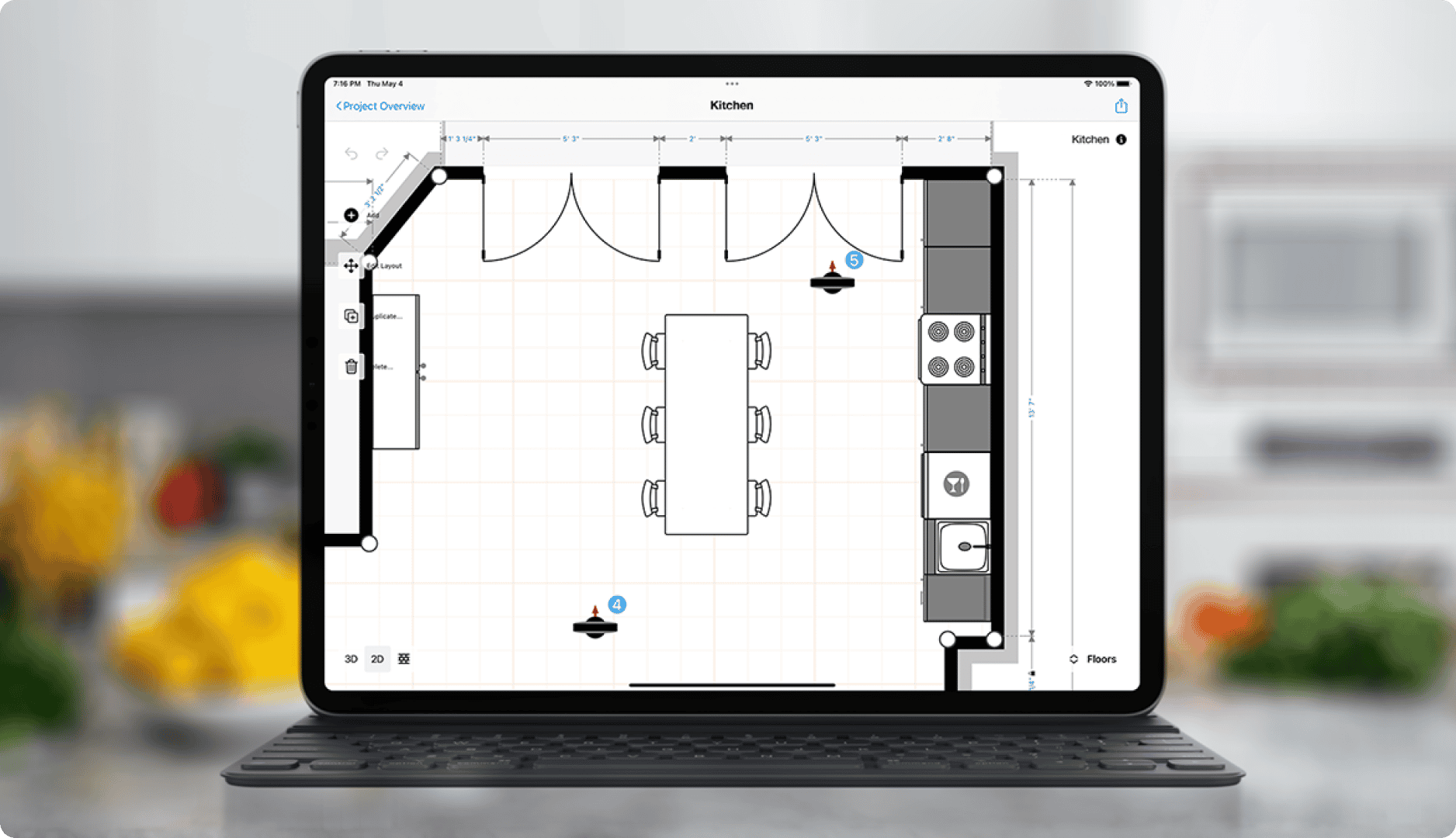 macbook pro with magicplan 2D floor plan project of a kitchen cabinets with dinning table