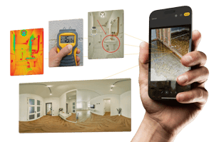 Restoration contractor holding phone taking photos of water damage site in a water mitigation restoration job