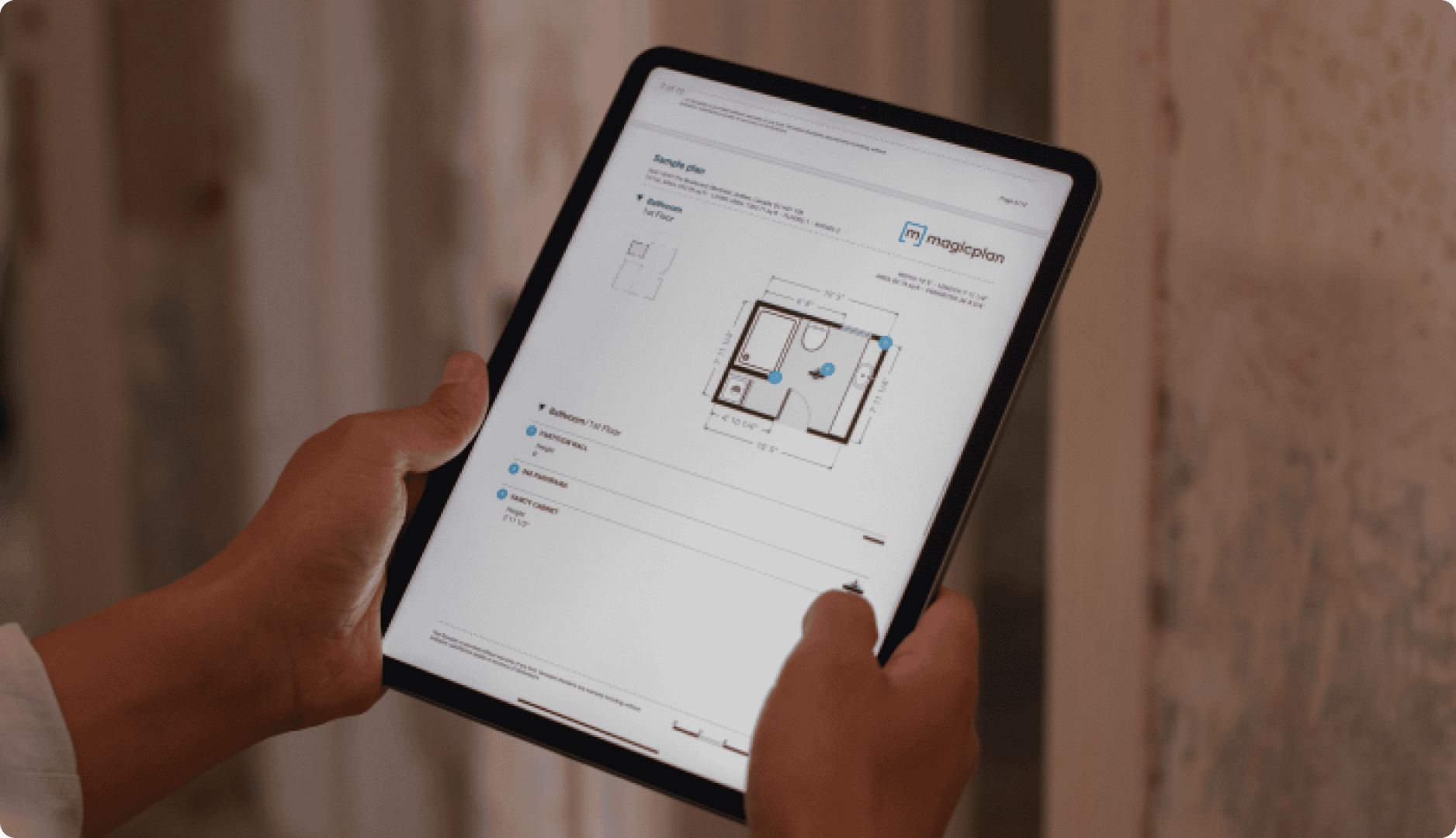 Contractor holding ipad with report of a property with floor plan