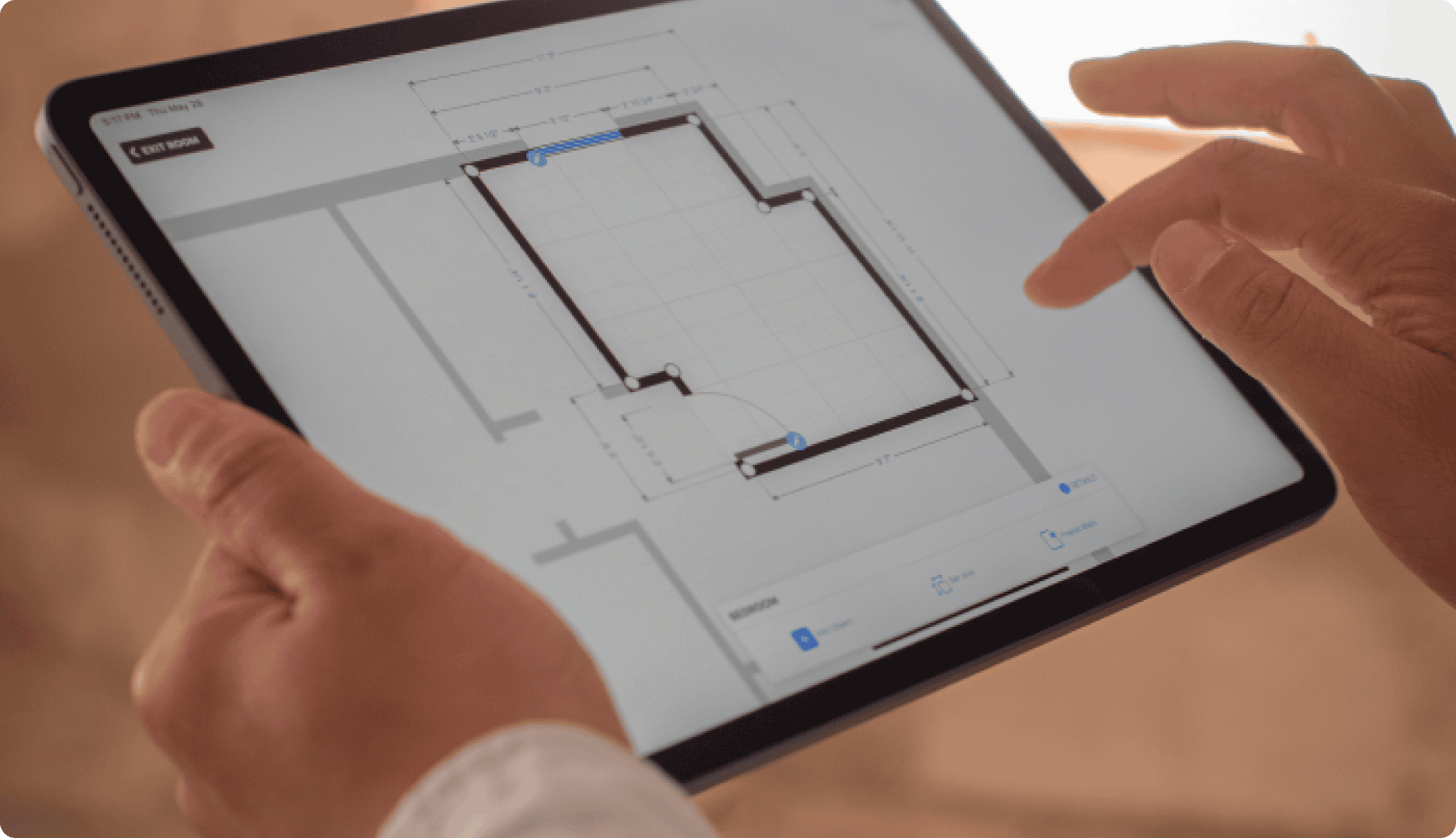Contractor with an ipad editing floor plan on magicplan app